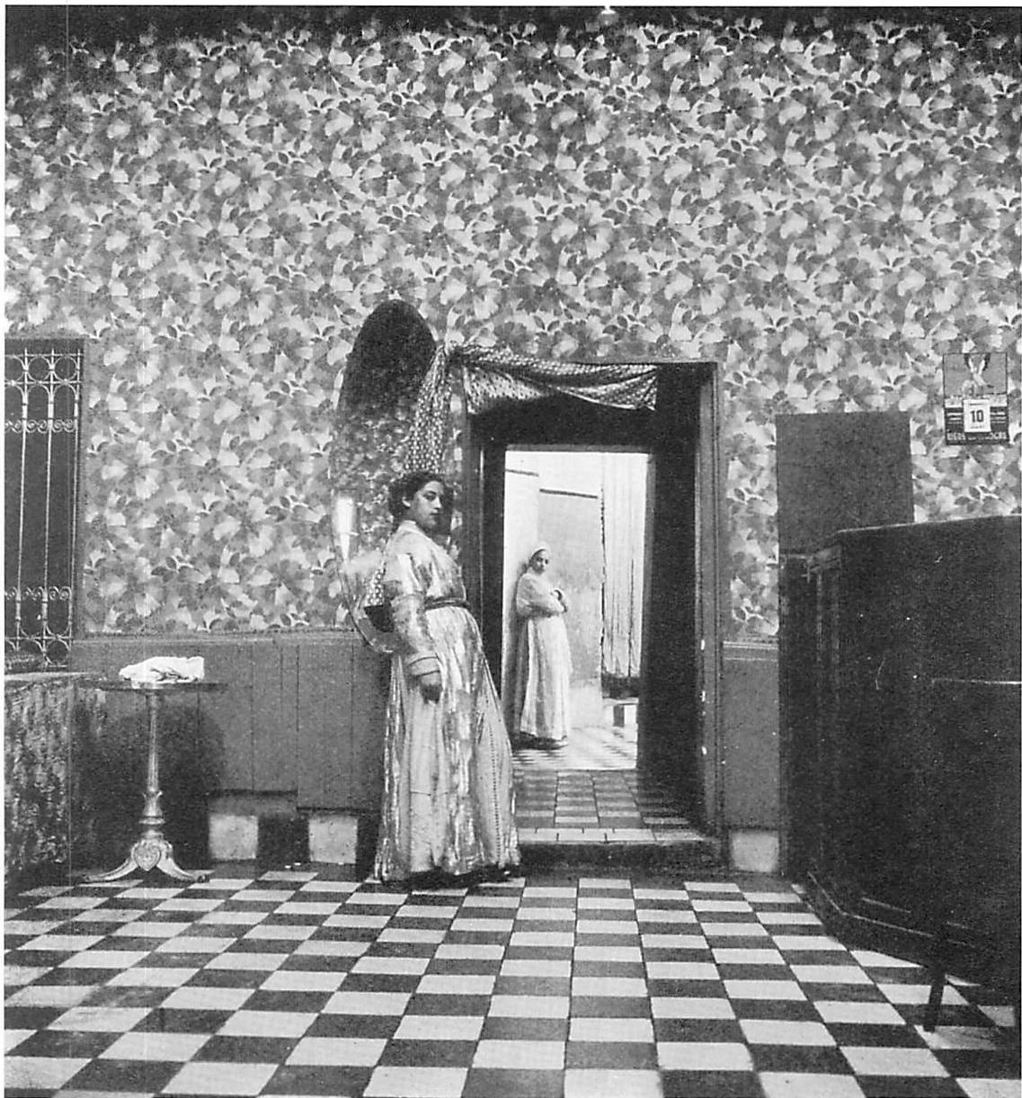 A mysterious interior in the Middle East. Beckoning women, the light falling in the room beyond, patterns on the floor and walls—these are the centers which create this atmosphere.