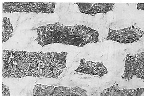 Stones laid in a thick bed of mortar that makes the boundary of the mortar as big, almost, as the stones themselves