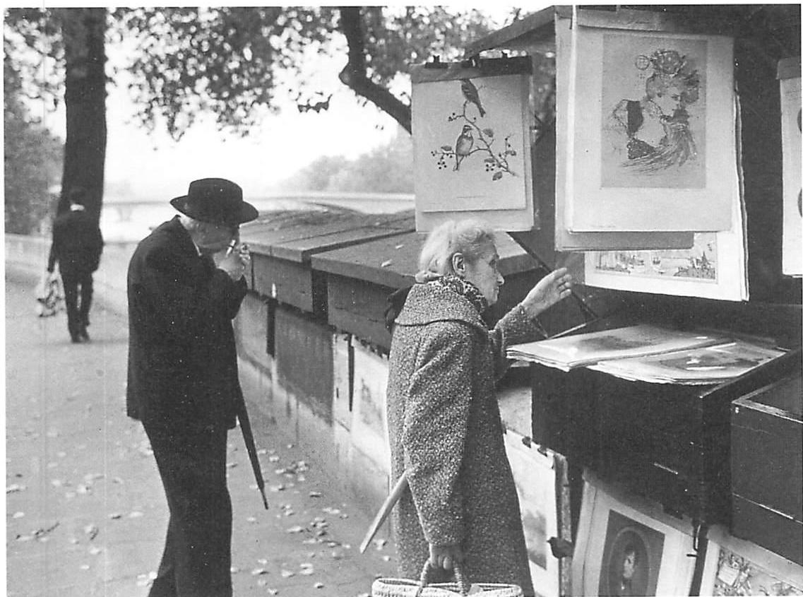 Looking through prints she cannot afford to buy