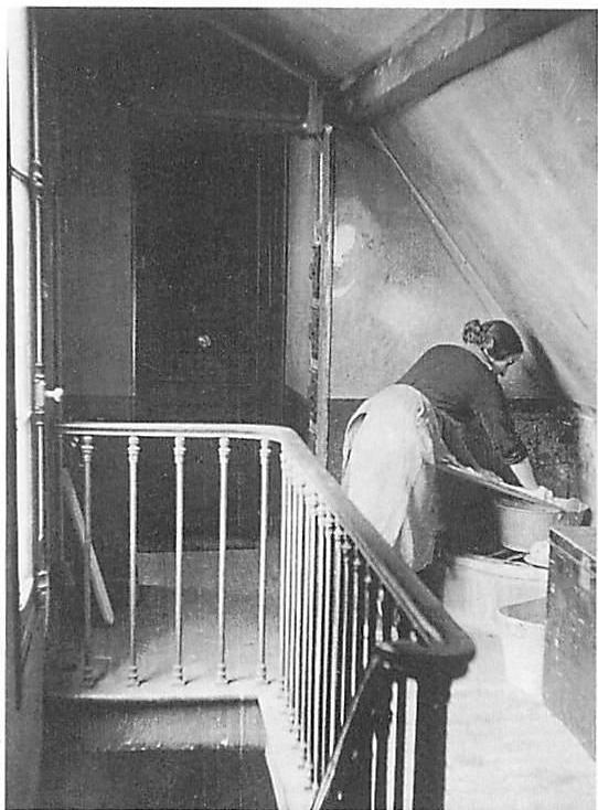 Doing the laundry in a corner of the attic apartment