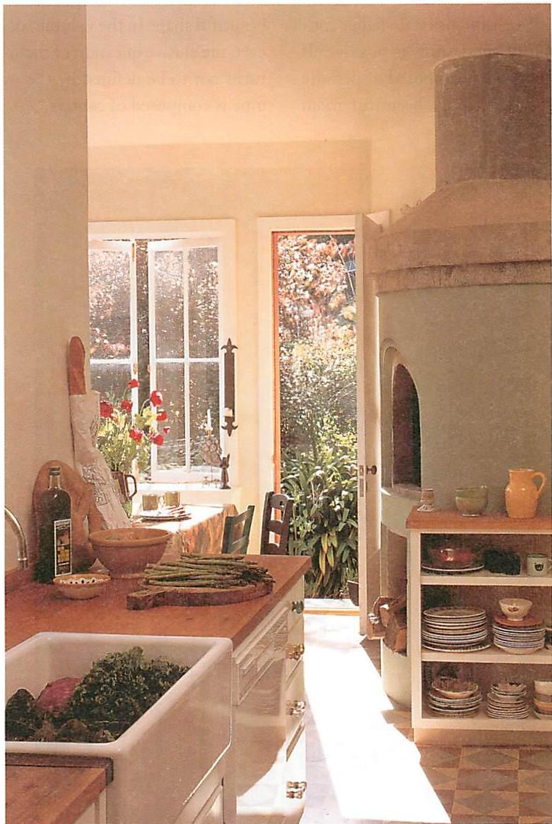 The sitting area in the distance, on the left, is tranquil, because the natural path through the kitchen leaves the sitting area alone. Kitchen of the Upham house, Berkeley, California. Christopher Alexander, 1992